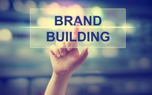 47808337 - hand pressing brand building on blurred cityscape background