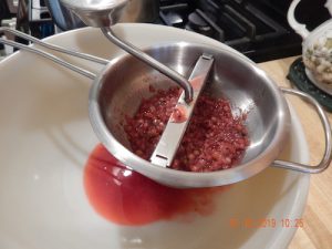putting currants through the food mill